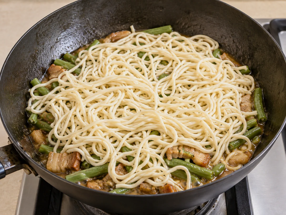 Boil the sauce and layer noodles
